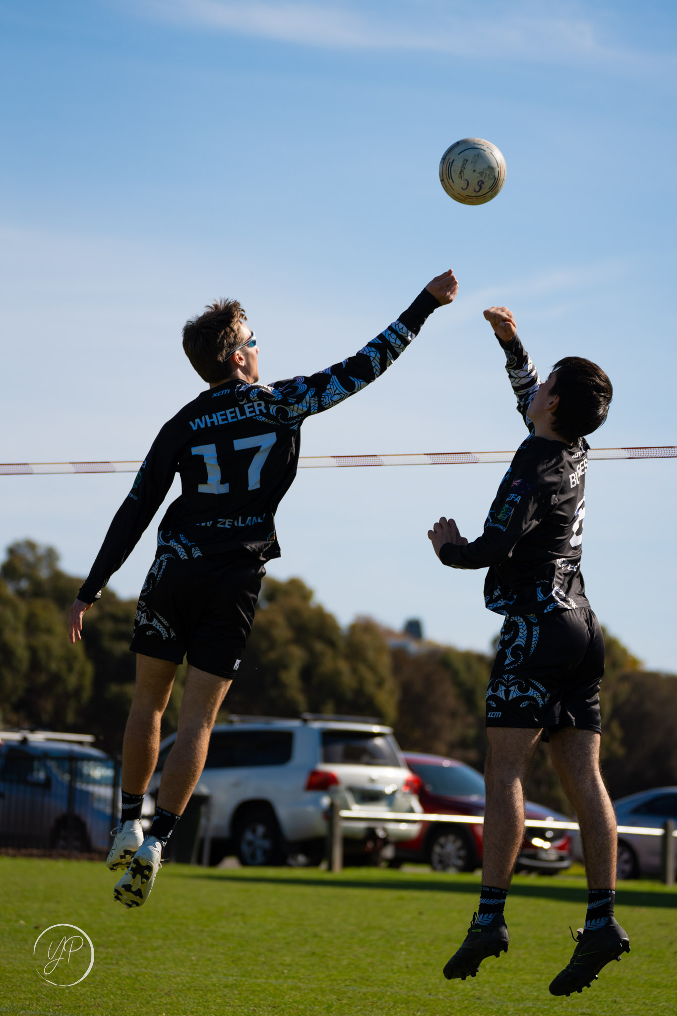 Two young men playing fistball