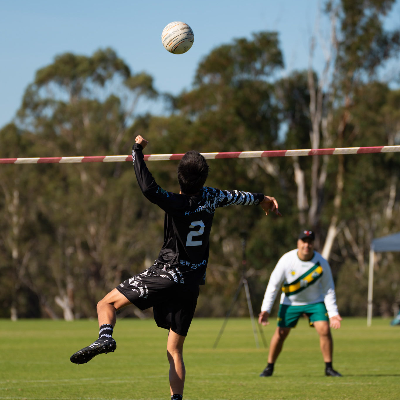 Two young men playing fistball