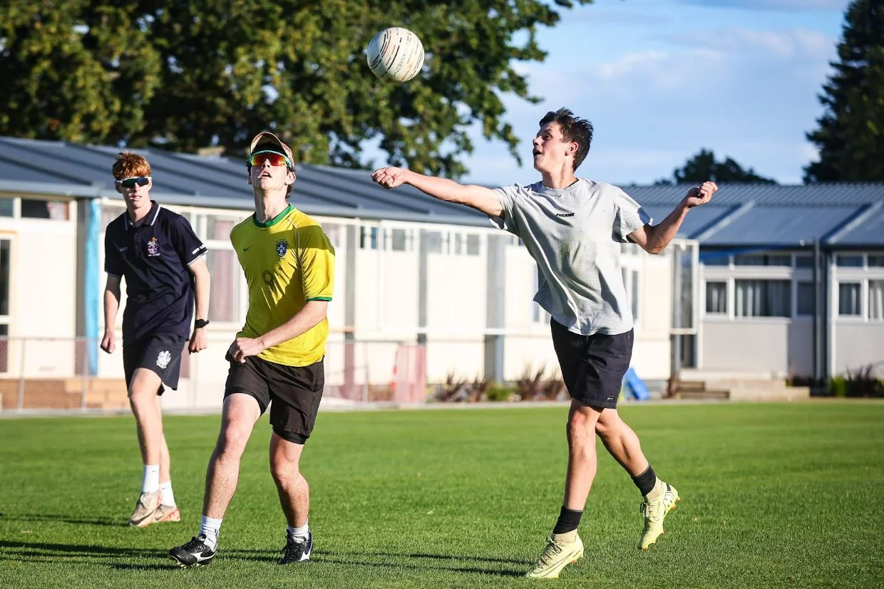 Reuben McKeown, Tristan Dyche and Marcel Giliomee playing fistball on Monday. Photo: AIMAN AMERUL MUNER / THE TIMARU HERALD